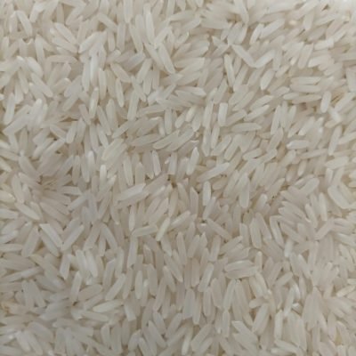 Detailed photo of uncooked white rice grains showcasing texture and abundance.
