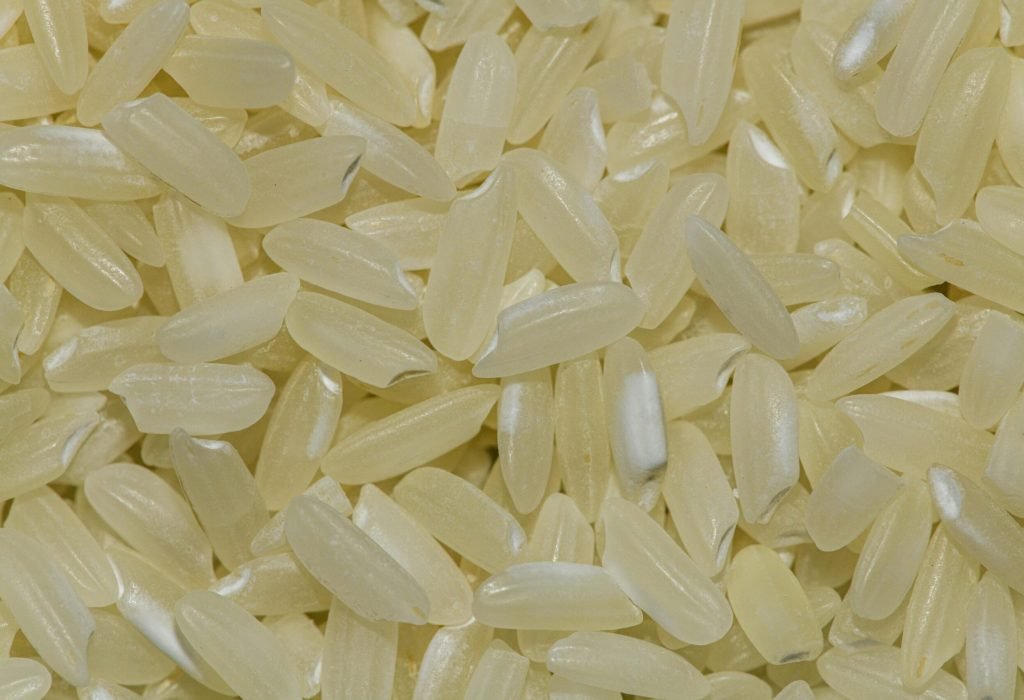 Detailed macro shot of uncooked rice grains, perfect for food and grain photography.